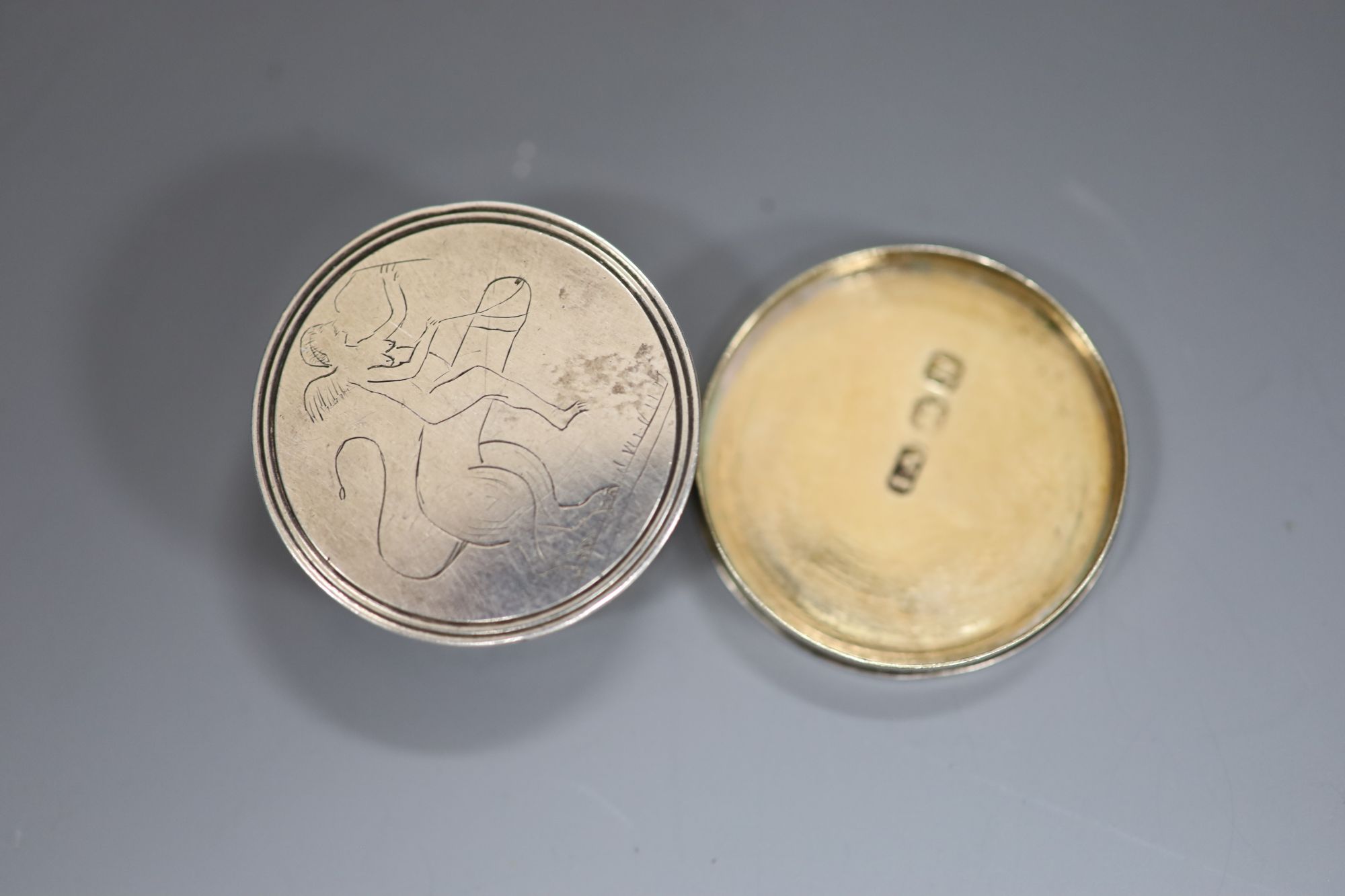 A George III silver circular vinaigrette with erotic engravings (faint), Joseph Ash I, London, 1808, 28mm.